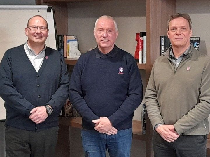 Experienced business professionals networking at an office event, promoting leadership and collaboration in a professional environment.